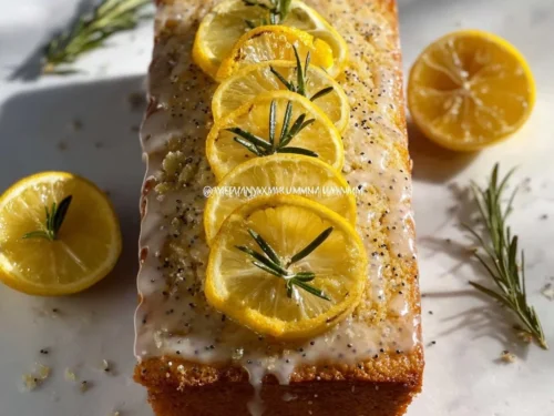 Sliced lemon poppy seed loaf cake drizzled with sweet lemon glaze.