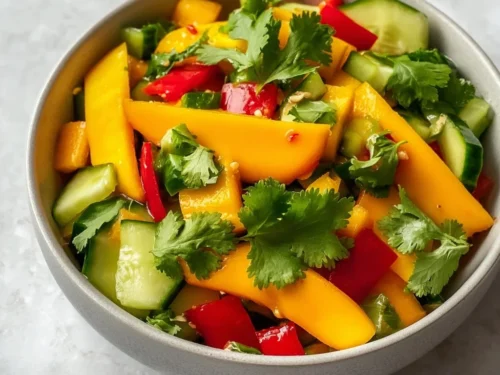 Vibrant Thai Mango Salad with fresh veggies and herbs for a healthy spring lunch.