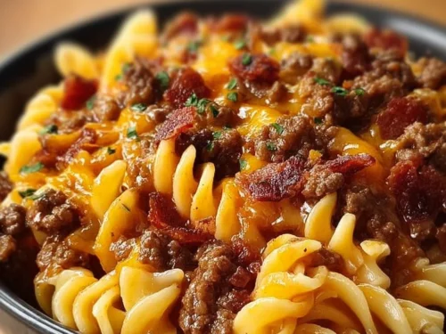 Delicious Loaded Bacon Cheeseburger Pasta topped with cheese and crispy bacon.